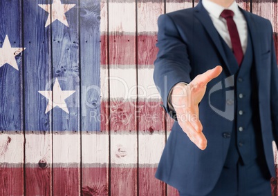 Business man shaking his hand against american flag