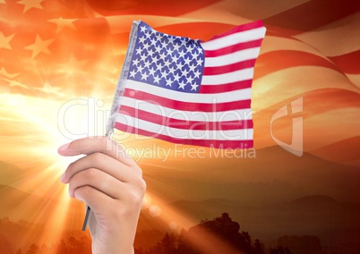 Hand holding an american flag for independence day