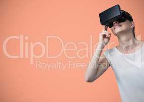 Woman in virtual reality headset against peach background