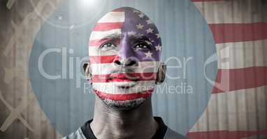 Portraiture of man with american flag against blurry wood panel with hand drawn american flag and fl
