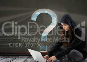 Woman hacker seated and working on a laptop with a grey background with a 3D question mark