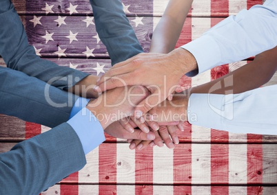 Business people with hands together against american flag