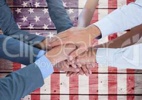 Business people with hands together against american flag