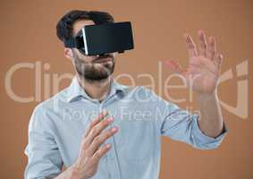 Man in virtual reality headset against brown background