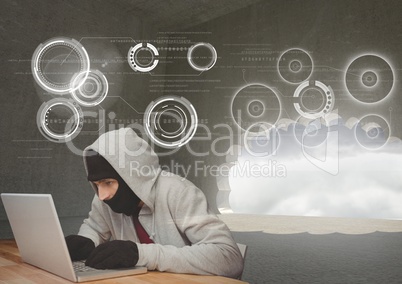 Hacker using a laptop in front of digital background