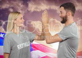 Couple high fiving against american flag