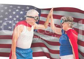 senior people high fiving against american flag