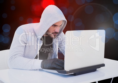 Hacker working on laptop with a digital background