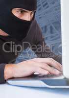 Close up of hacker working on laptop