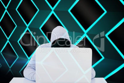 Masked hacker using a white laptop
