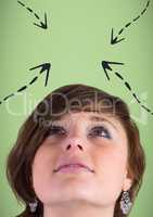 Woman looking up at 3D grey arrows against green background