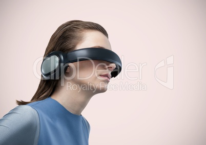 Woman in virtual reality headset against pink background