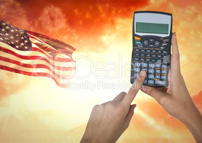 Hand holding a calculator  against american flag