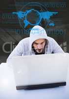 Hacker using a laptop in front of digital drawings
