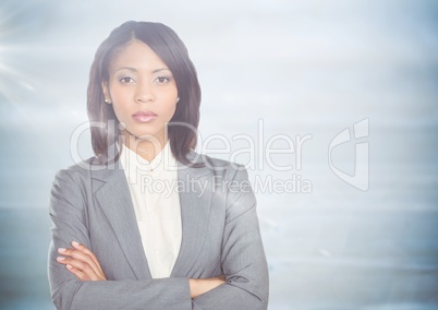 Business woman arms folded against blurry blue wood panel