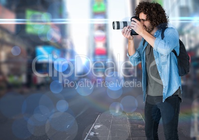 photographer taking a photo in the city. Blurred lights and flares everywhere.