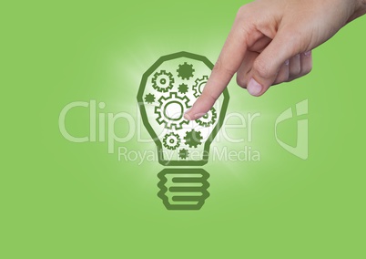 Hand pointing at cogs in 3d lightbulb graphic and flare against green background