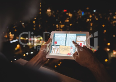 hands touching tablet with 3d hand drawn at night in a balcony