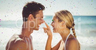 Confetti against couple on beach