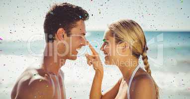 Confetti against couple on beach