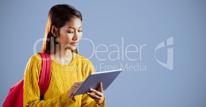 College student with tablet against purple background
