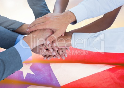 Business people with hands together against american flag