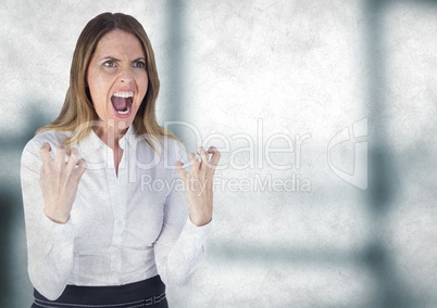 Angry business woman against blurry grey office with grunge overlay