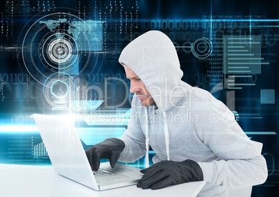 Hacker with glove using a laptop in front of digital background