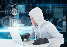Hacker with glove using a laptop in front of digital background