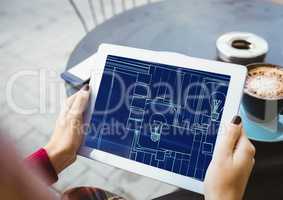 hands with tablet with blueprint on it (two-tone: dark blue and light blue)