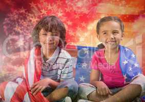 Children seated covered by american flag