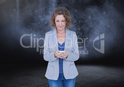 Woman texting in darkness