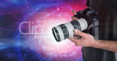 Photographer holding a camera against galaxy background