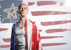 Man wrapped in american flag against hand drawn american flag and white wall with flare