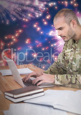 3d Soldier using a laptop with a fireworks in background