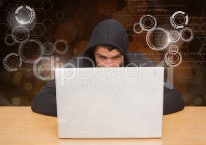 Hacker using a laptop in front of digital orange background