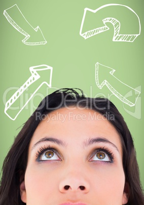 Top of woman's head looking up at white arrows against green background