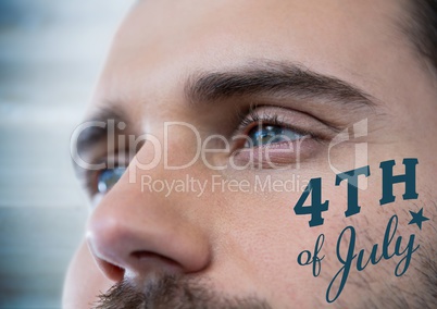 Close up of man's eyes with blue fourth of July graphic against blurry blue wood panel