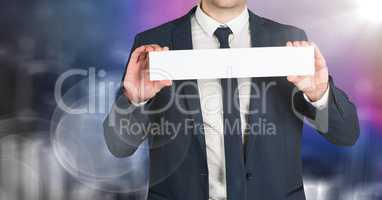 Business man mid section with blank card against blurry purple wall and flare