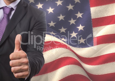 Business man with thumbs up against american flag