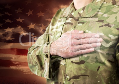 Close up of soldier with hand on heart in front of american flag