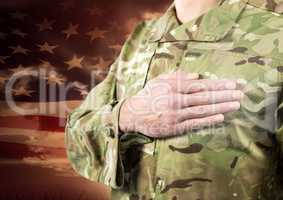 Close up of soldier with hand on heart in front of american flag