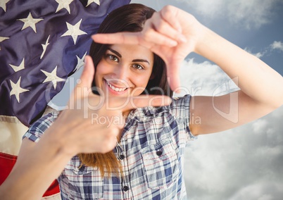 Smiling woman making a square with her hands for independence day