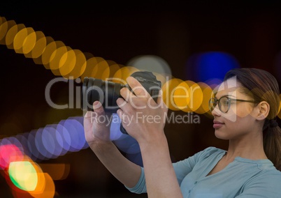 Photographer in front of lights bokeh