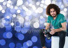 3d photographer with camera on the hands, sitting. Blue bokeh background