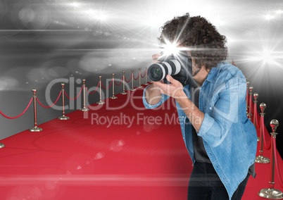 photographer taking a photo with flash in the red carpet. Flares everywhere