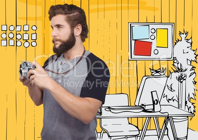 Millennial man with camera against yellow hand drawn office