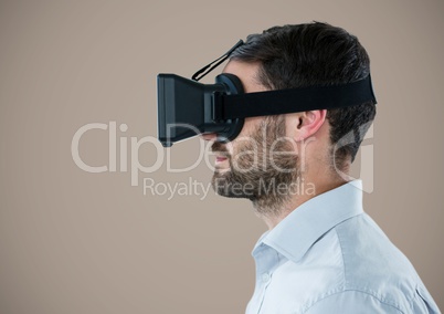 Man in virtual reality headset against light brown background