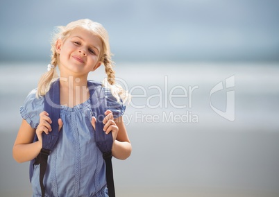 Schoolgirl against blurry beach