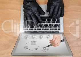Hands with glove using a laptop with drawings on screen